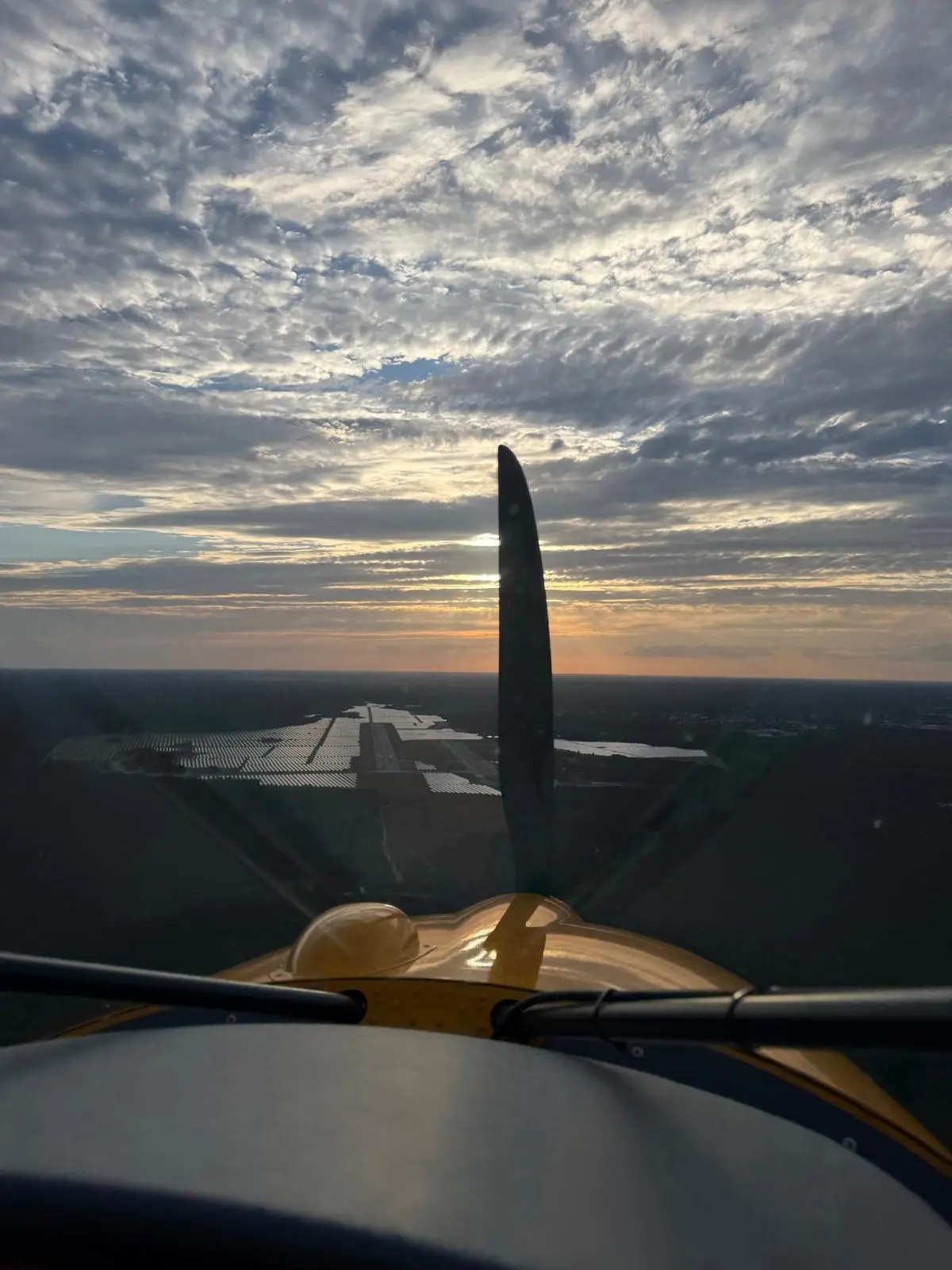 Anflug im Abendlicht mit Landebahn voraus und Propeller im Bild
